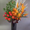roses and pin cushion black vase arrangement